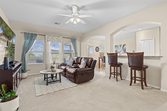 living room featuring ceiling fan and light colored carpet