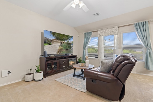 carpeted living room with lofted ceiling and ceiling fan