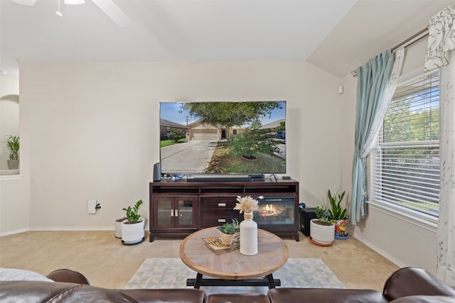 living room with lofted ceiling, light colored carpet, and ceiling fan