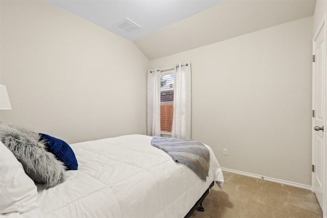 bedroom featuring vaulted ceiling and light colored carpet