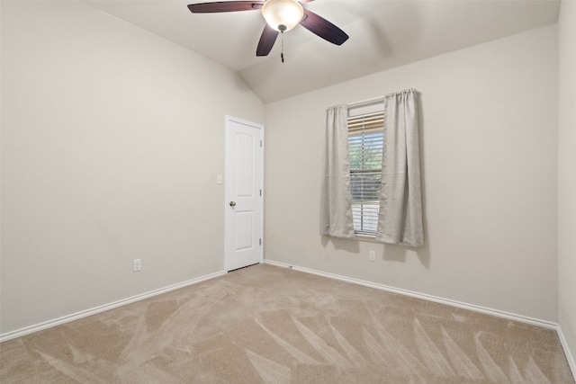 empty room with lofted ceiling, ceiling fan, and light carpet