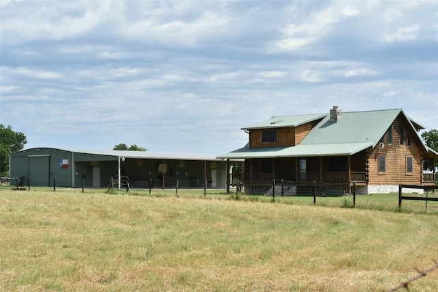 exterior space featuring metal roof and a chimney