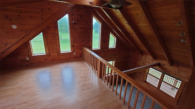 interior space with a wealth of natural light, light hardwood / wood-style flooring, and lofted ceiling with beams