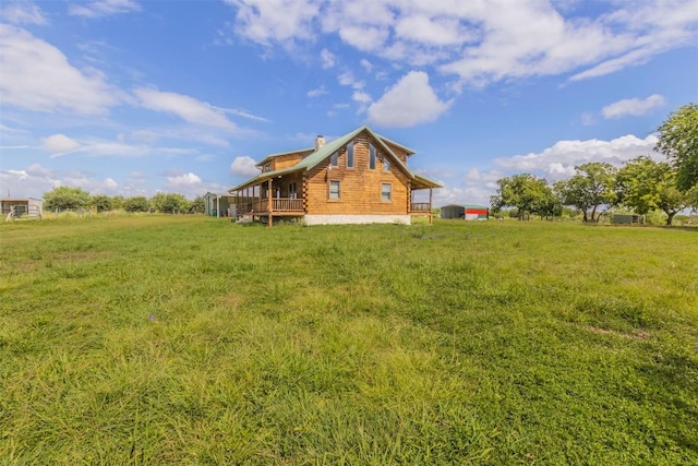 rear view of house with a chimney and log siding