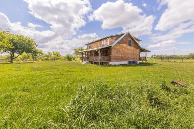 view of yard featuring a rural view and a wooden deck