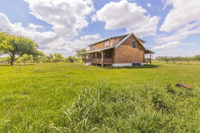 rear view of house with a lawn, log siding, and central air condition unit