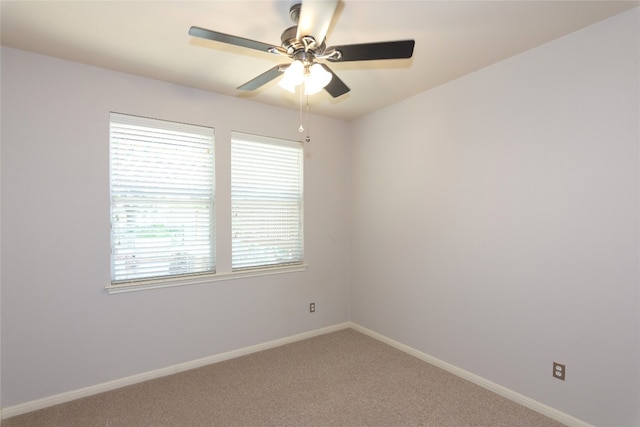 carpeted empty room featuring plenty of natural light and ceiling fan