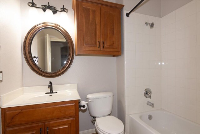 full bathroom featuring vanity, tiled shower / bath combo, and toilet