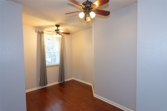 spare room with dark wood-type flooring and ceiling fan