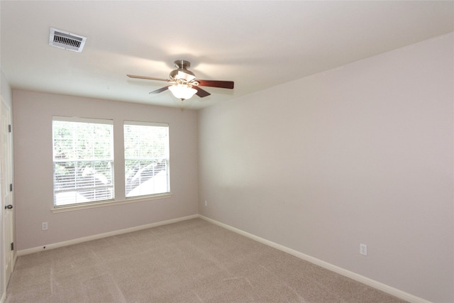 carpeted spare room with ceiling fan