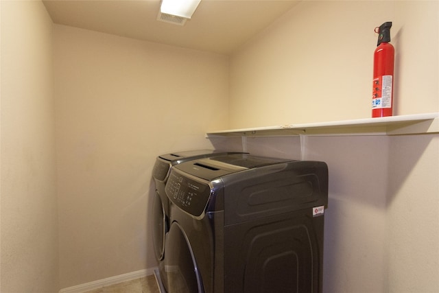 clothes washing area featuring washing machine and clothes dryer