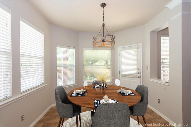 tiled dining space with a chandelier