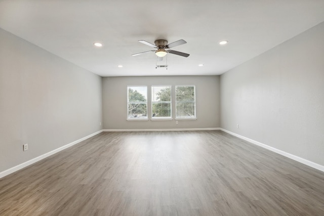 empty room featuring ceiling fan and wood-type flooring