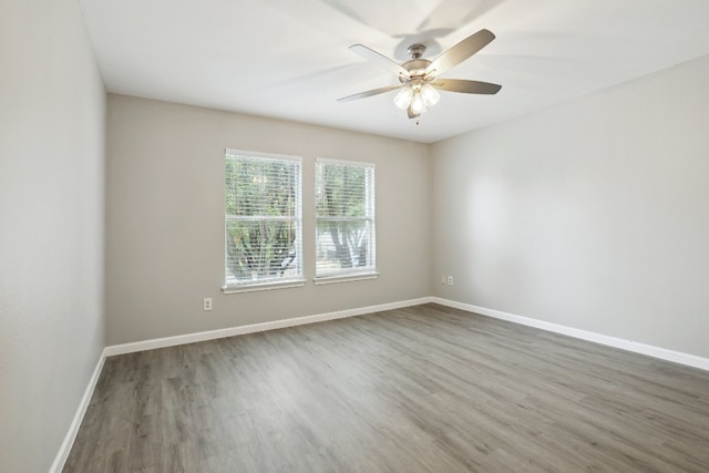 spare room featuring wood-type flooring and ceiling fan