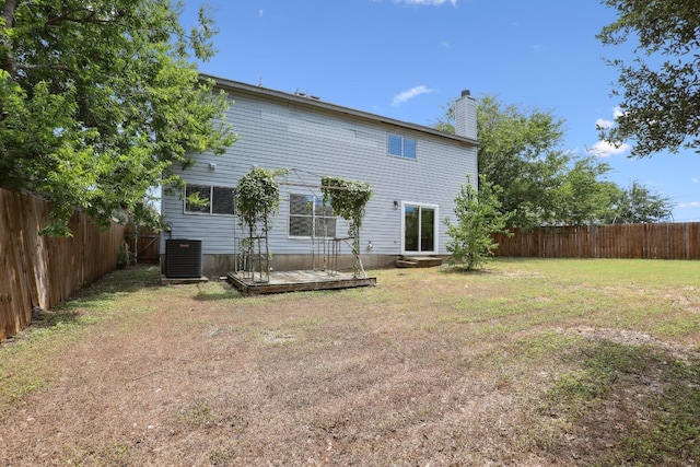 back of house featuring a wooden deck and a yard