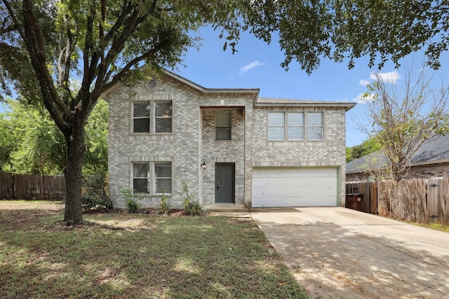 view of front of property with a garage and a front lawn