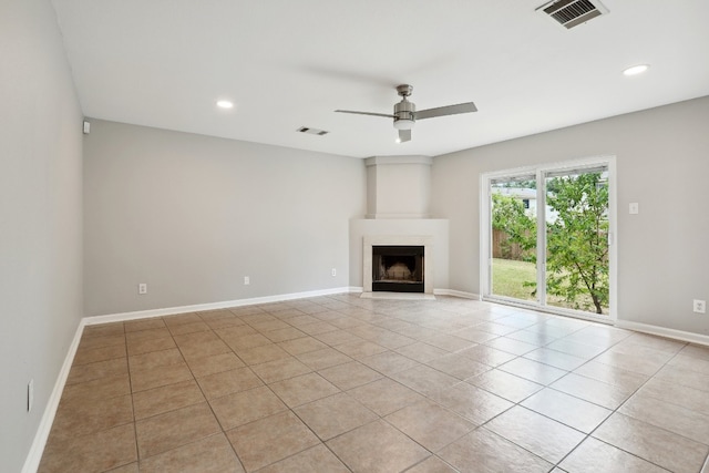 unfurnished living room with light tile patterned floors and ceiling fan