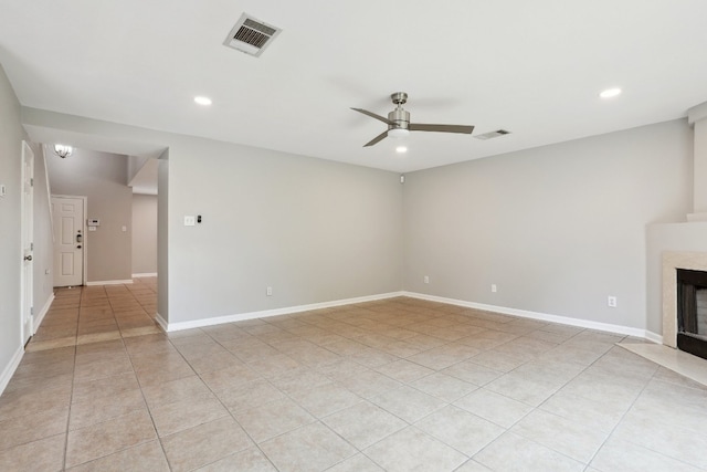 spare room with ceiling fan and light tile patterned floors