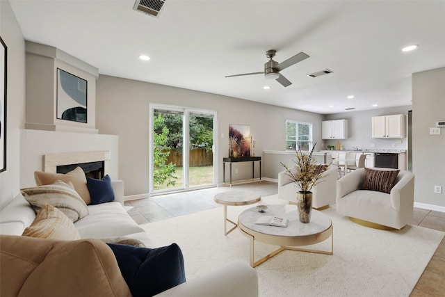 tiled living room with ceiling fan