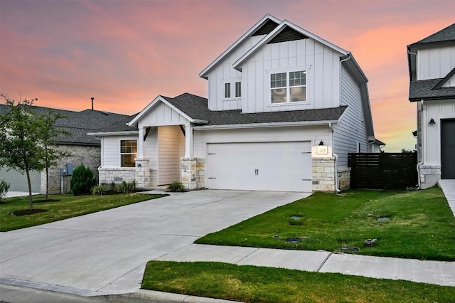 view of front facade with a garage and a lawn