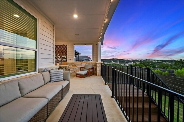 balcony at dusk featuring outdoor lounge area