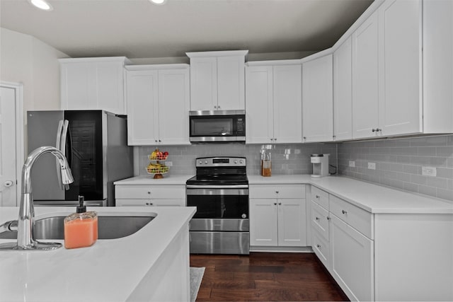 kitchen featuring white cabinetry, appliances with stainless steel finishes, sink, and dark hardwood / wood-style flooring