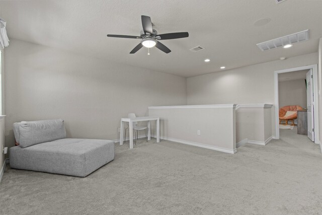 sitting room featuring light carpet and ceiling fan