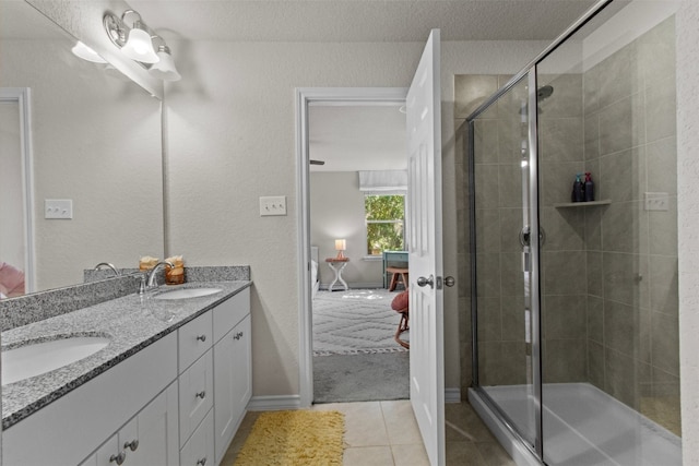 bathroom with vanity, walk in shower, a textured ceiling, and tile patterned flooring