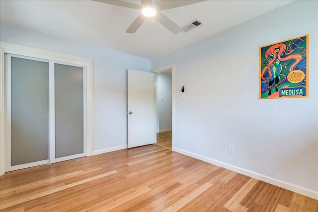 unfurnished bedroom with a closet, light hardwood / wood-style floors, and ceiling fan