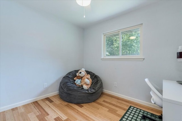 living area featuring wood finished floors and baseboards