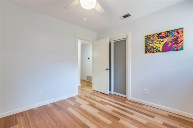 unfurnished bedroom with light wood-style flooring, visible vents, and baseboards