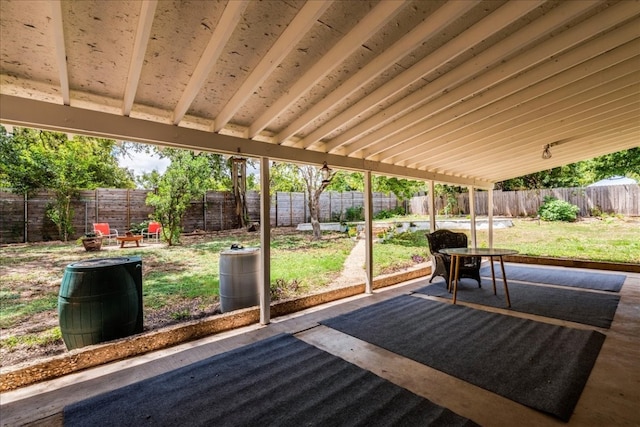 unfurnished sunroom featuring lofted ceiling with beams