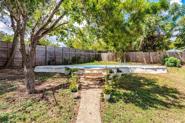 view of yard featuring a fenced in pool and a fenced backyard