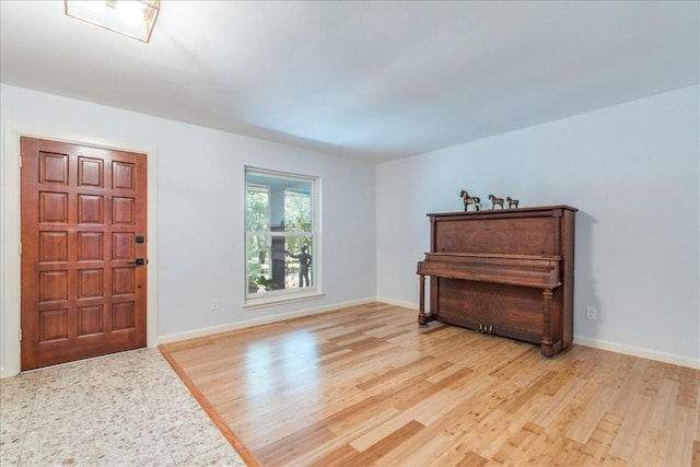 entryway featuring light wood-type flooring and baseboards