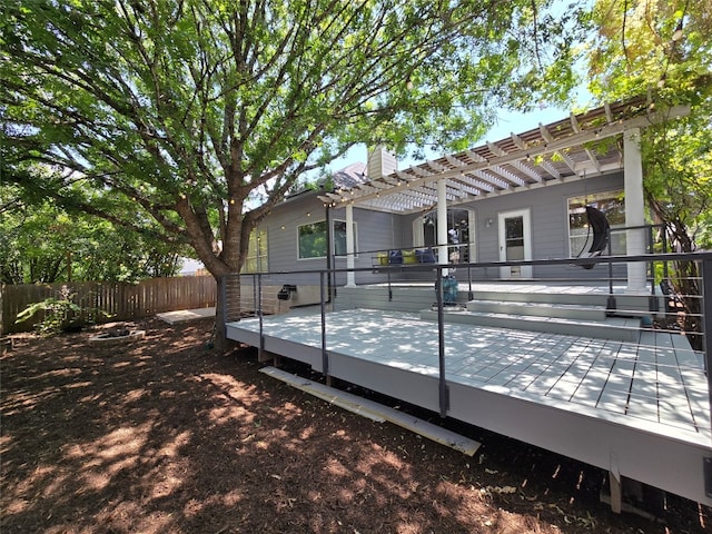 back of property featuring a pergola and a deck