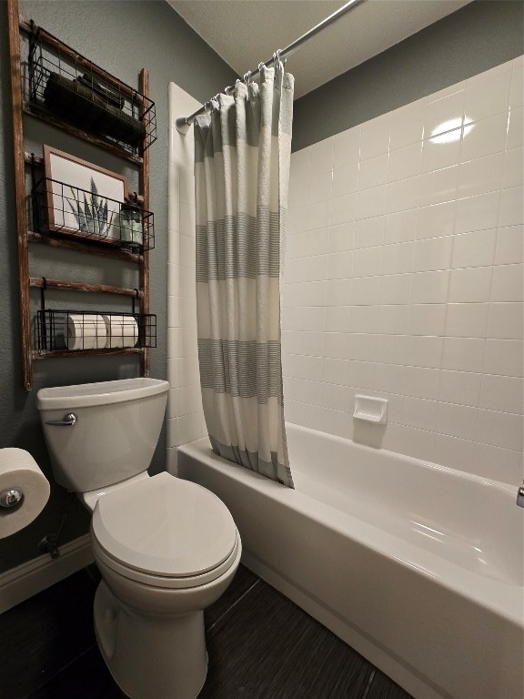 bathroom with toilet and shower / bath combo