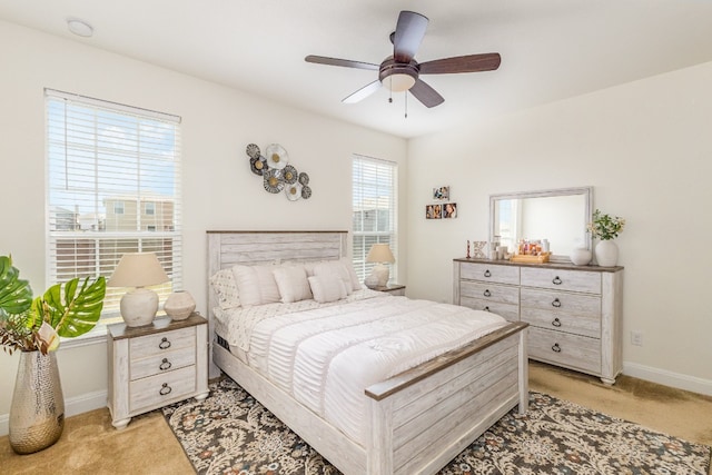 bedroom featuring light carpet and ceiling fan