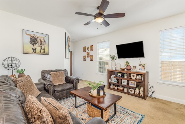 carpeted living room with ceiling fan