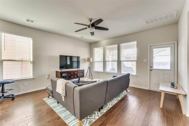 living room featuring hardwood / wood-style floors and ceiling fan