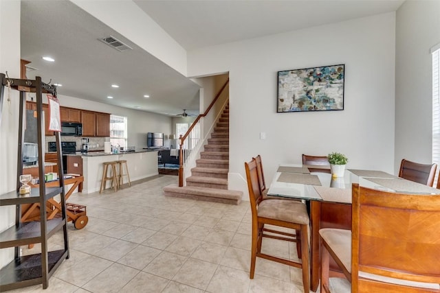 dining area featuring visible vents, recessed lighting, light tile patterned floors, and stairs