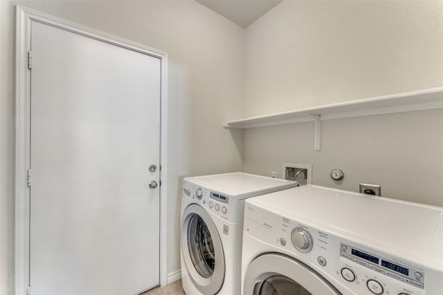 washroom with independent washer and dryer and laundry area