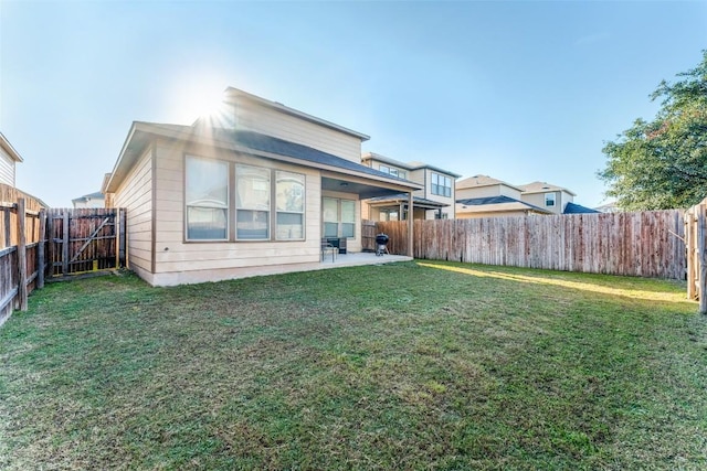 back of property featuring a patio area and a lawn