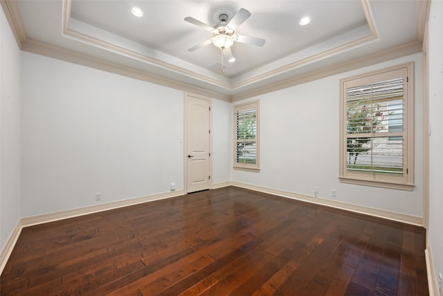 spare room with ceiling fan, crown molding, dark hardwood / wood-style flooring, and a tray ceiling