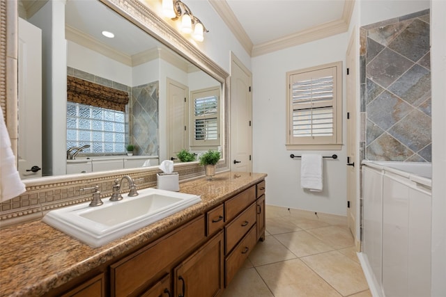 bathroom with a bath, vanity, tile patterned floors, and ornamental molding