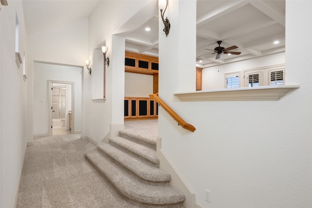 stairs with coffered ceiling, carpet flooring, and beamed ceiling