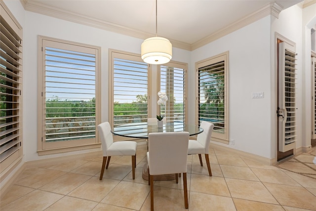 dining area featuring ornamental molding and light tile patterned flooring