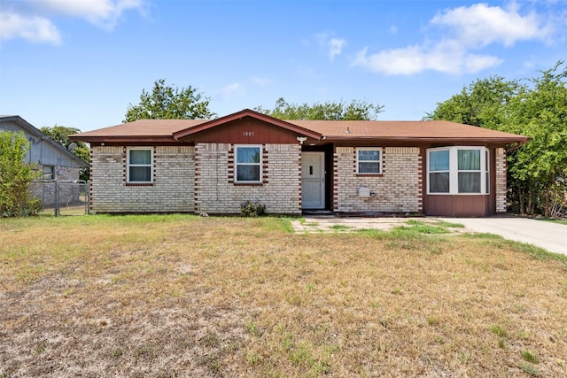 ranch-style home featuring a front yard