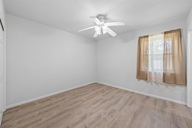 spare room featuring light hardwood / wood-style flooring and ceiling fan