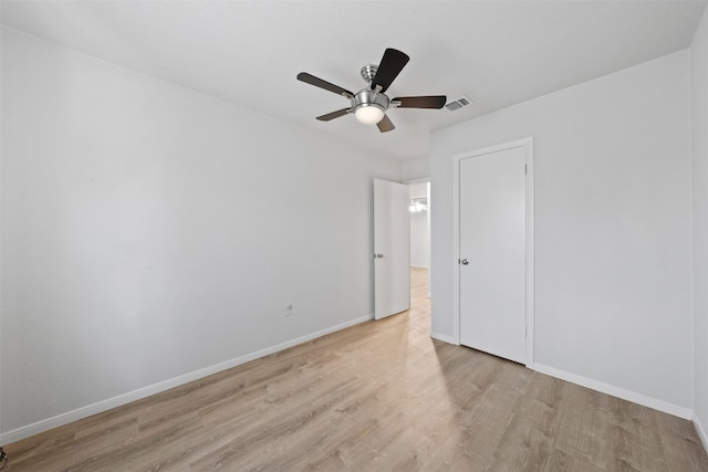 empty room featuring ceiling fan and light hardwood / wood-style floors