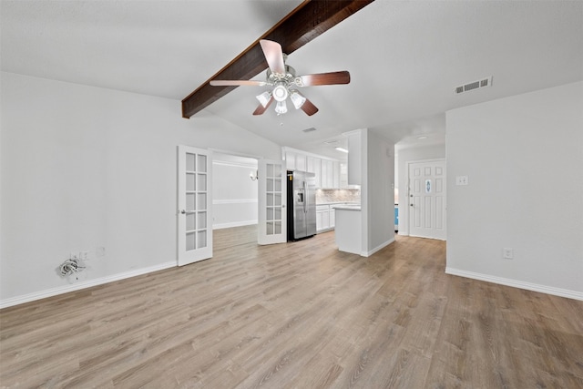 unfurnished living room featuring light wood-type flooring, french doors, ceiling fan, and vaulted ceiling with beams